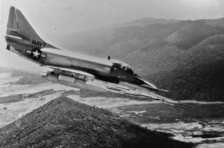 A US Navy Douglas A-4E Skyhawk from Attack Squadron 23 (VA-23) “Black Knights” fires rockets at Viet Cong targets in South Vietnam in 1965. (US Navy)